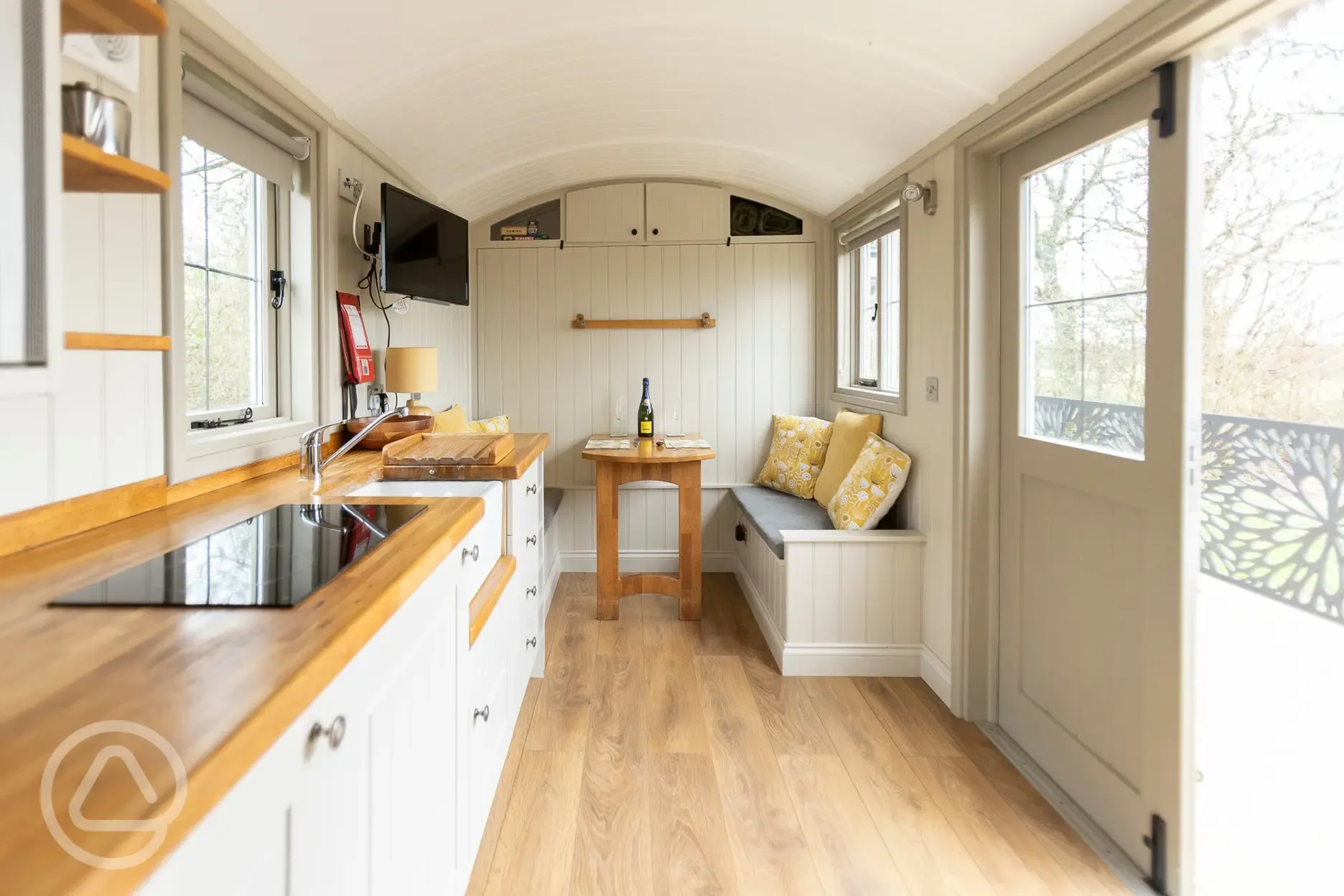 Shepherds hut interior with kitchen and dining area