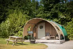 Glamping cabin exterior, sleeping two with outdoor seating and decking