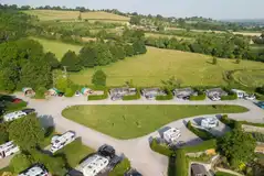 Aerial of the super pitches and glamping cabins with fields in the distance