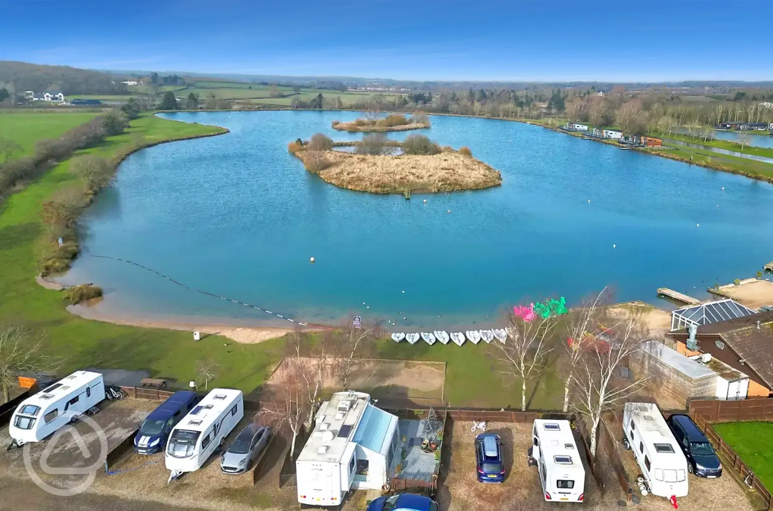 Aerial of the waterside fully serviced gravel touring pitch