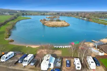 Aerial of the waterside fully serviced gravel touring pitch