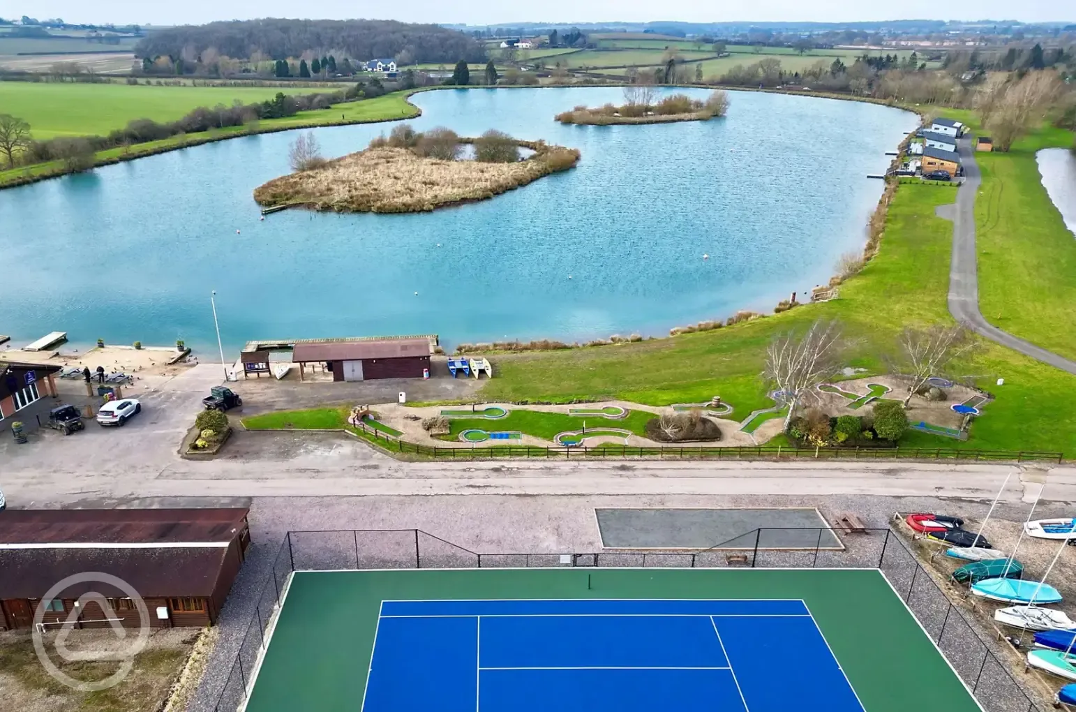 Aerial of facilities - lake, tennis court and crazy golf