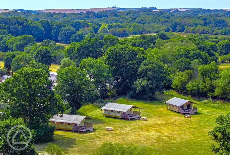 Aerial of the safari tent area on the edge of a large meadow