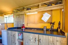 Safari tent kitchen with a hob, toaster, fridge/ freezer and kettle