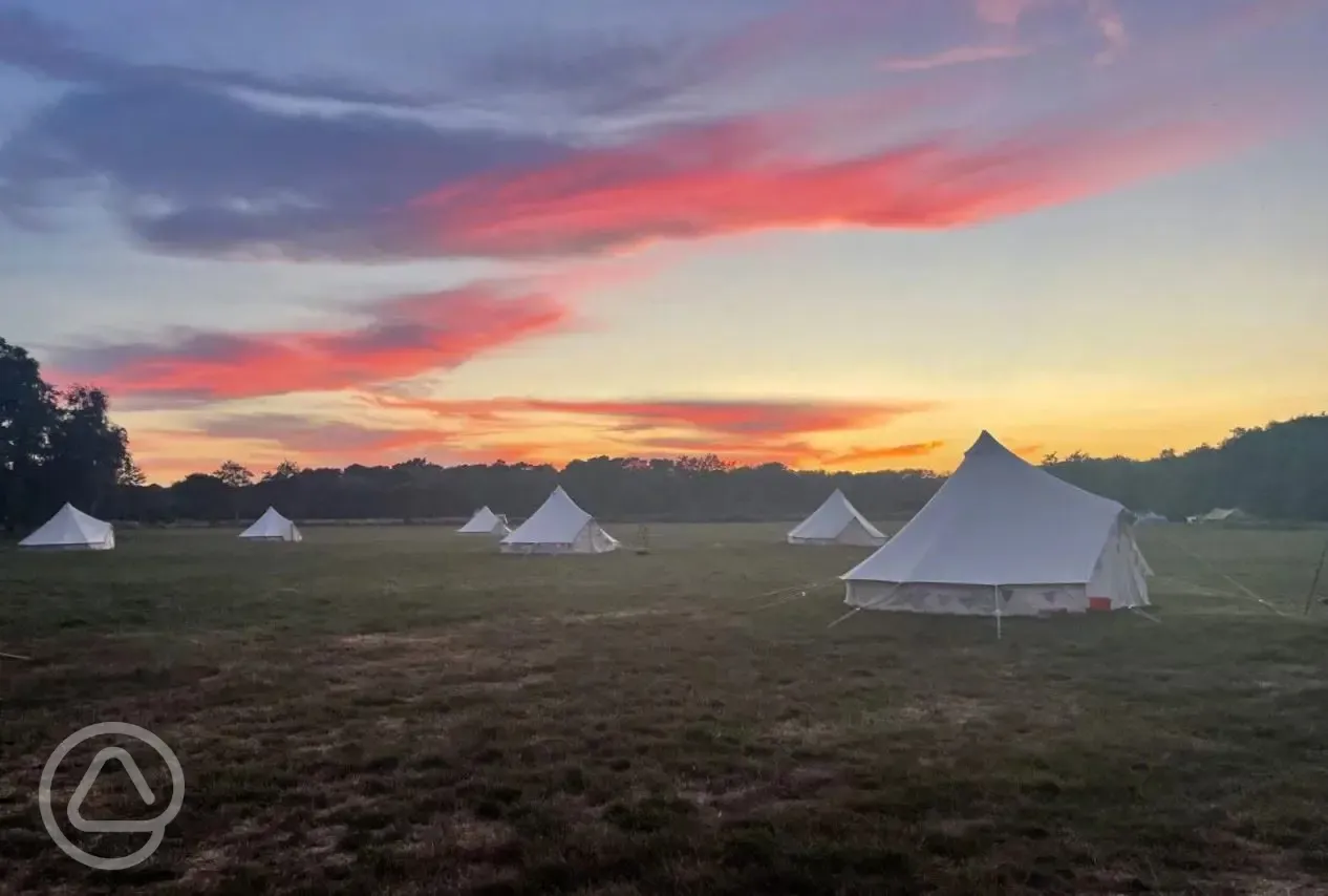Unfurnished bell tents at sunset