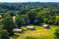 Aerial of the safari tent area on the edge of a large meadow