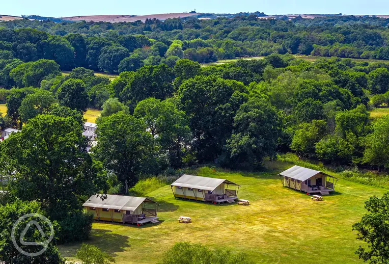 Aerial of the safari tent area on the edge of a large meadow