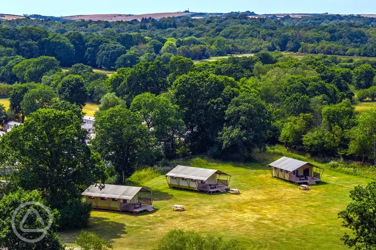 Aerial of the safari tent area on the edge of a large meadow