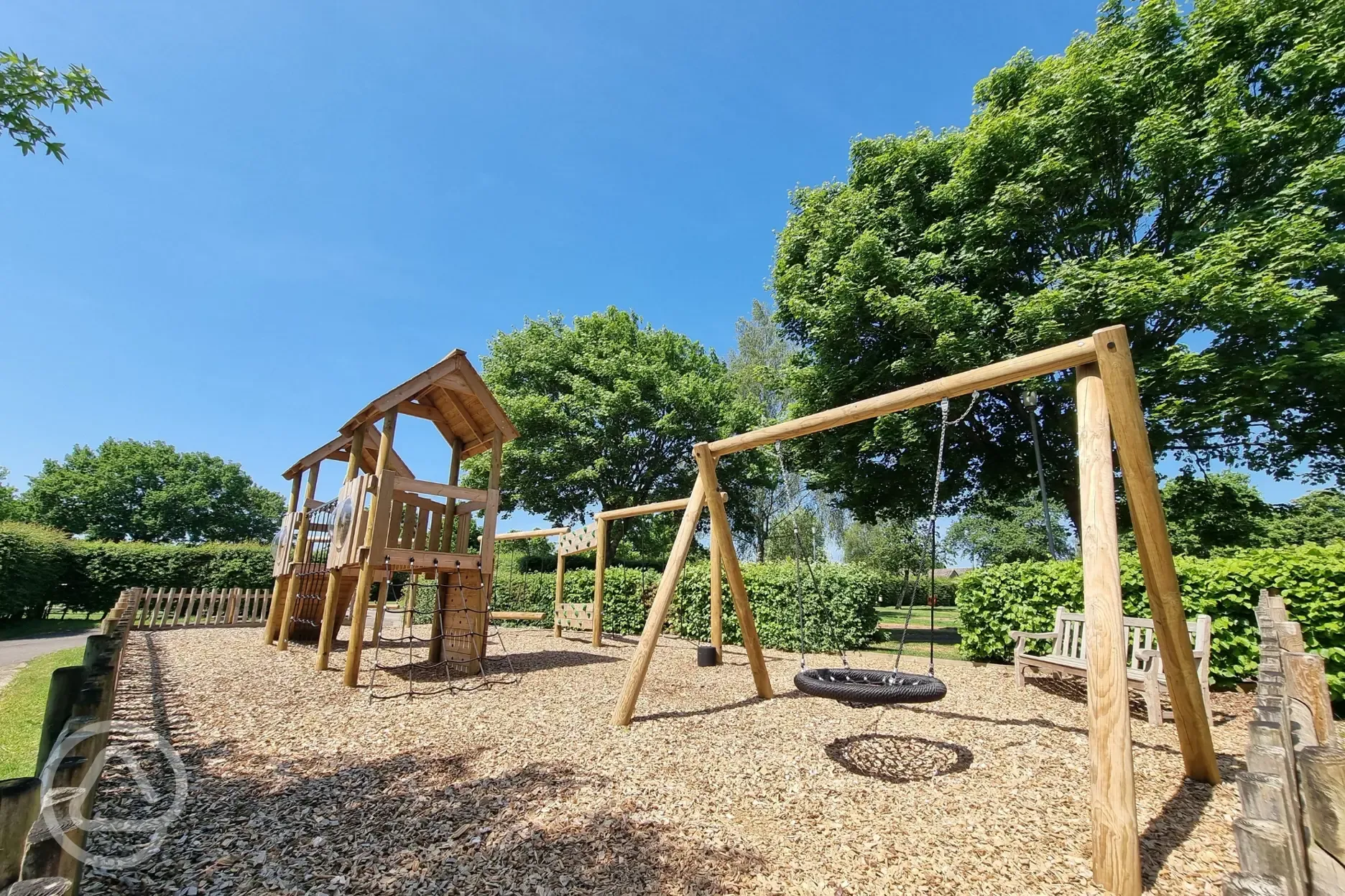Play park with wooden climbing frames and a swing