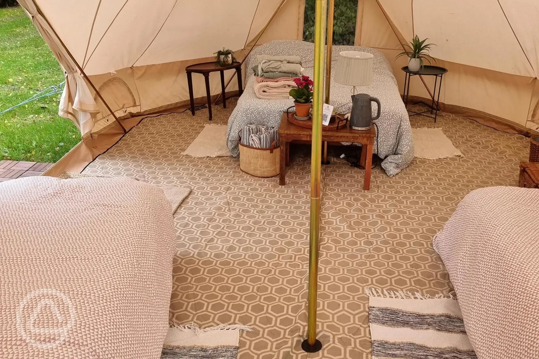 Large furnished bell tent with a double bed and up to three air beds