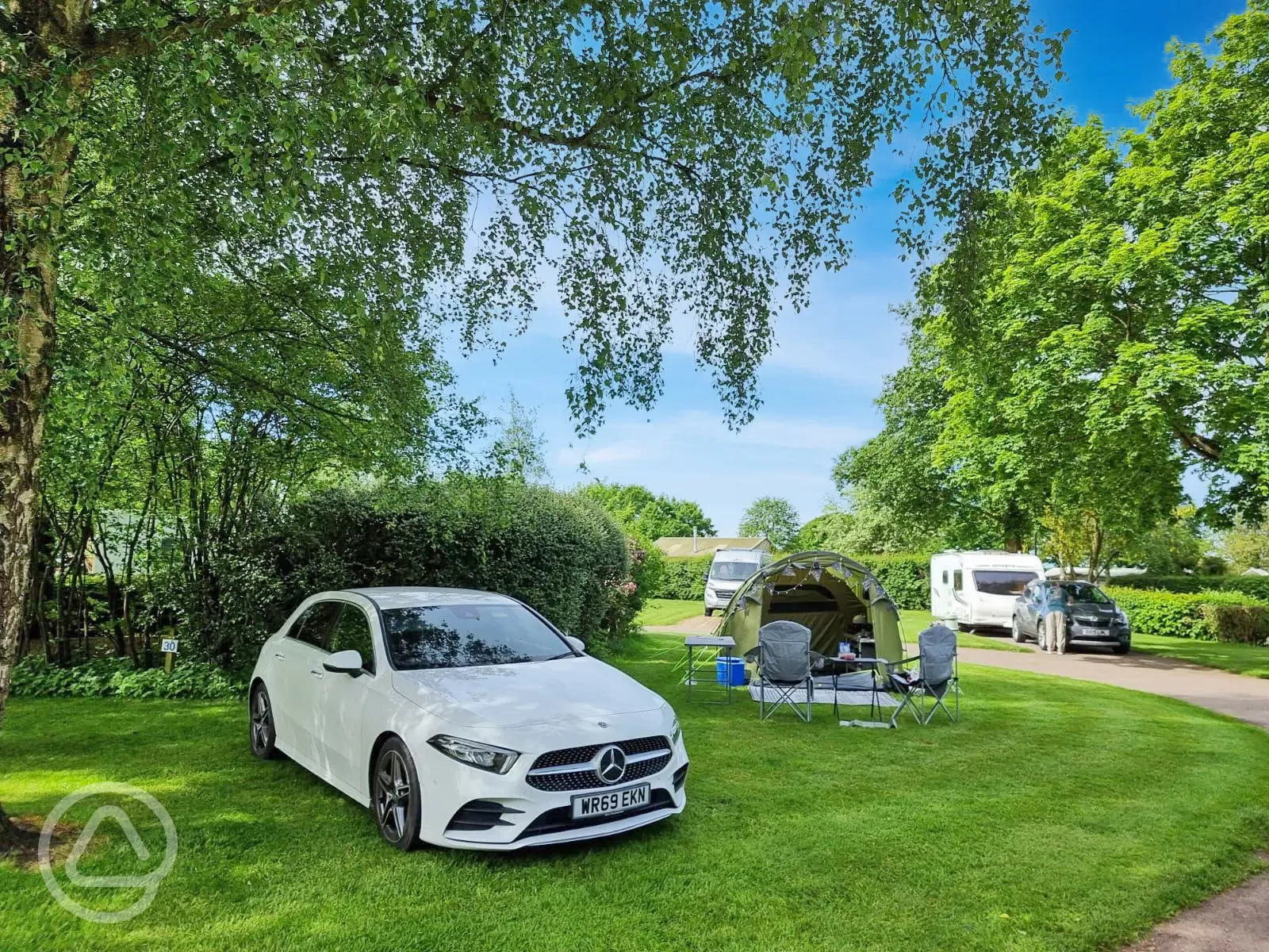 Non electric grass tent pitches under the shade of trees