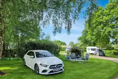 Non electric grass tent pitches under the shade of trees Non electric grass tent pitches under the shade of trees