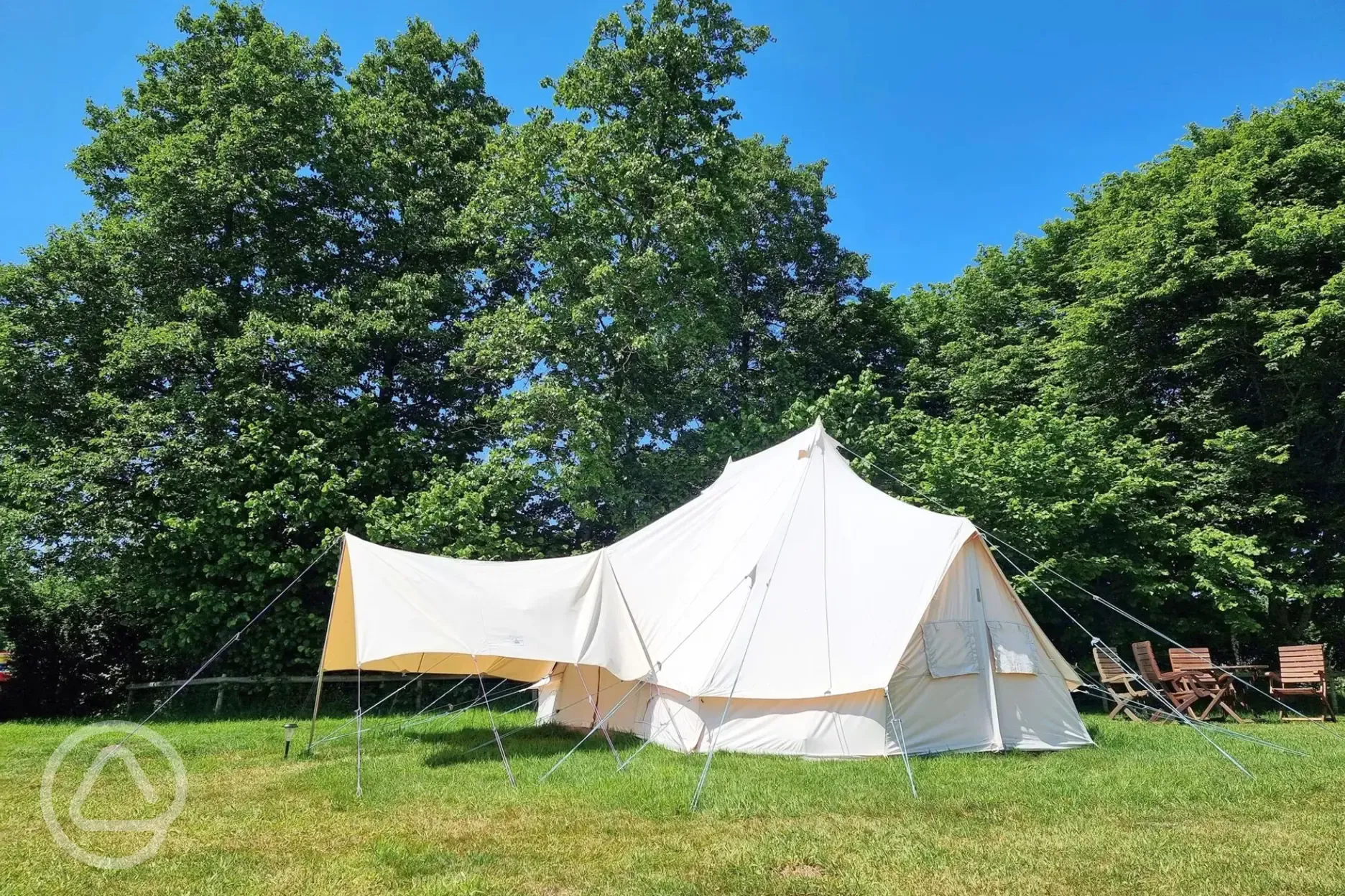 Large furnished bell tent with outdoor seating