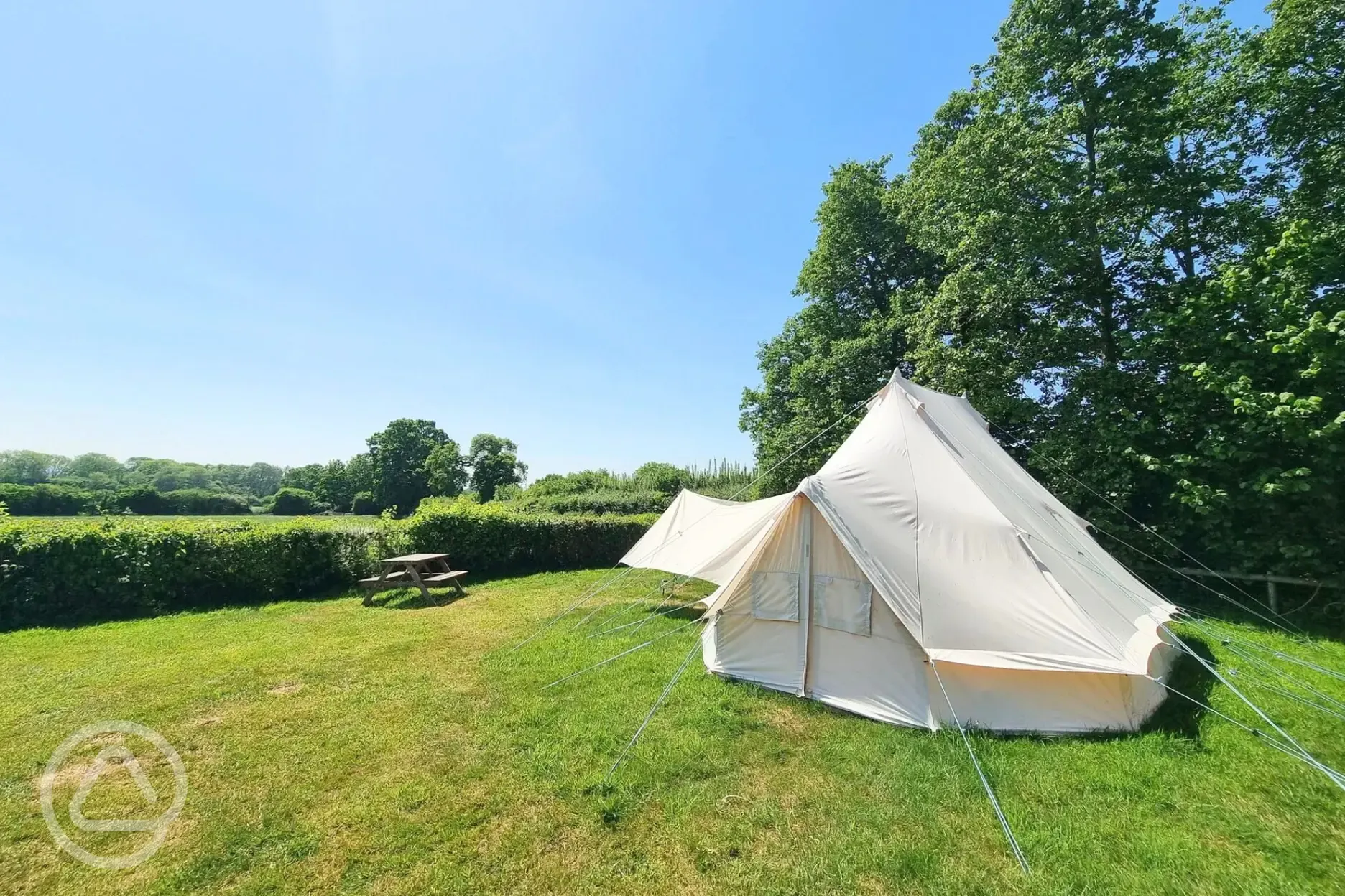 Large furnished bell tent with a picnic bench
