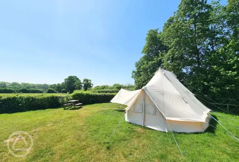 Large furnished bell tent with a picnic bench