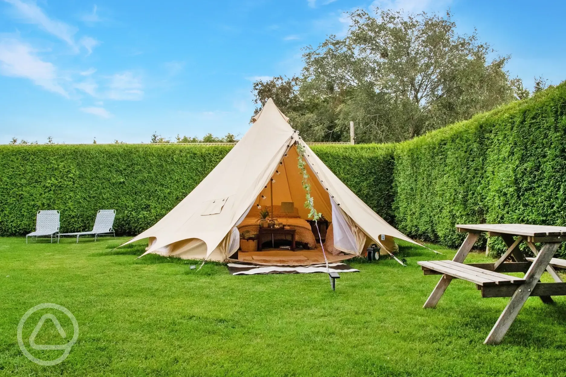 Furnished bell tent with a double bed and twin air beds
