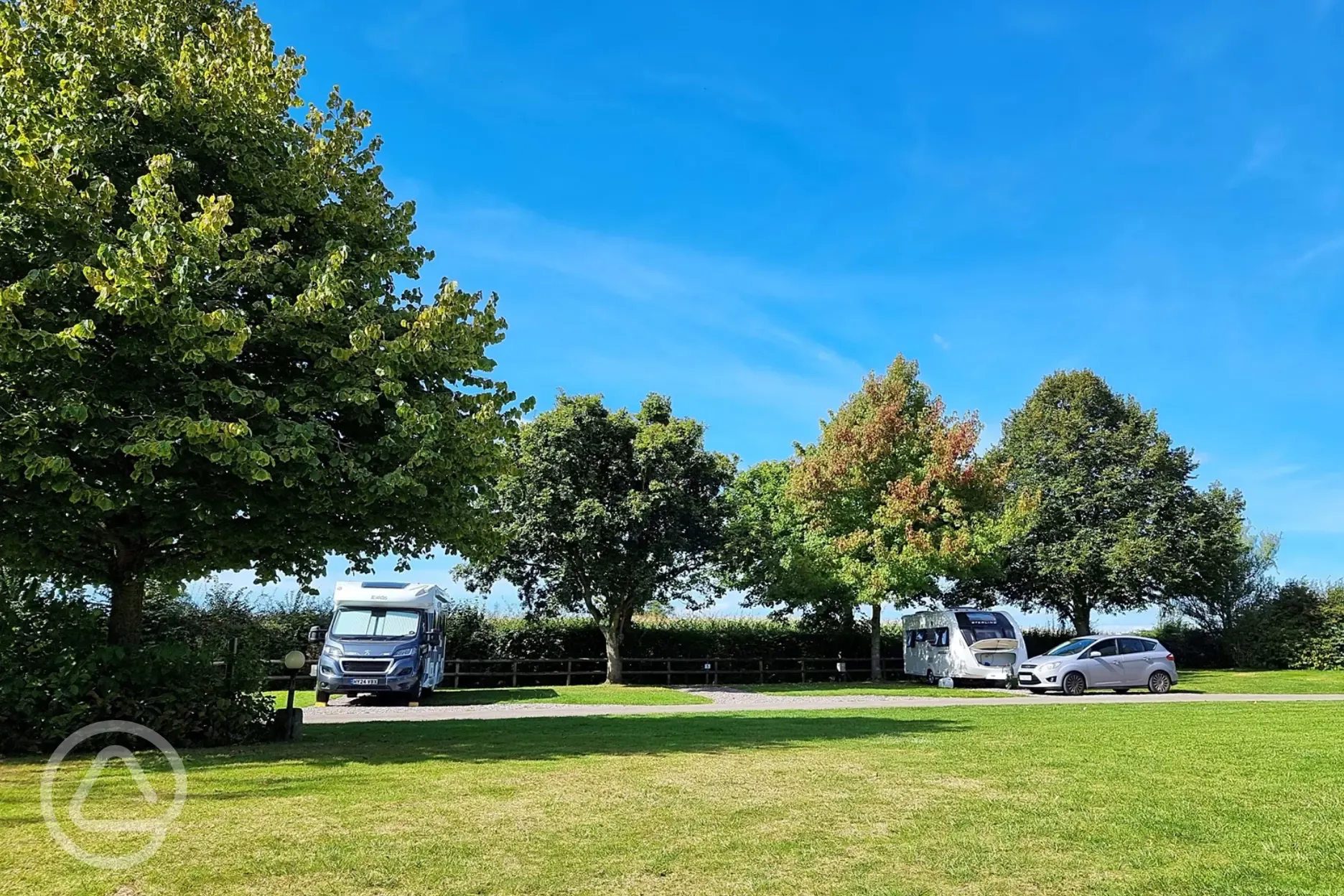 Electric hardstanding pitches with 16 amp hook ups and grass between pitches