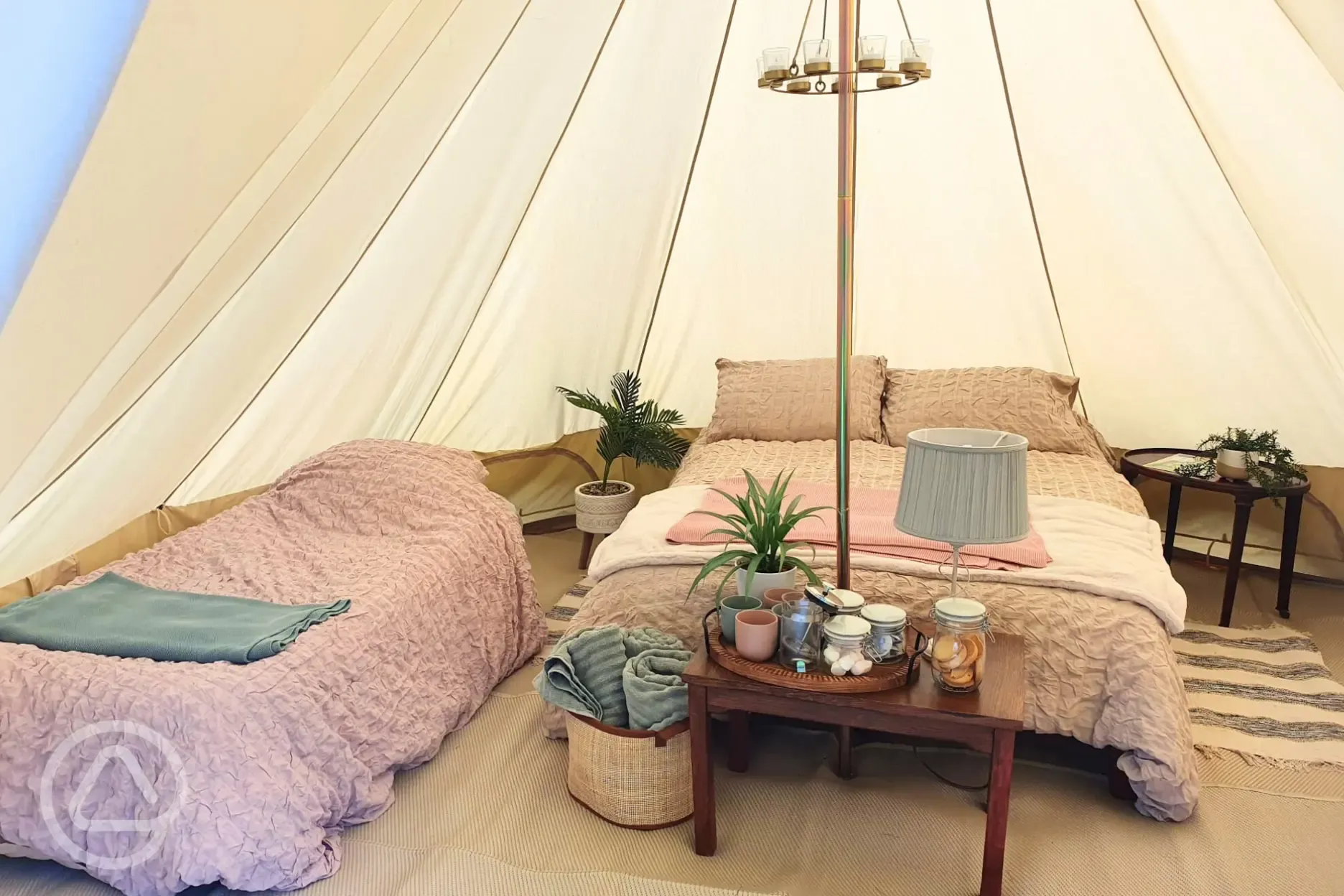 Furnished bell tent with a double bed and twin air beds