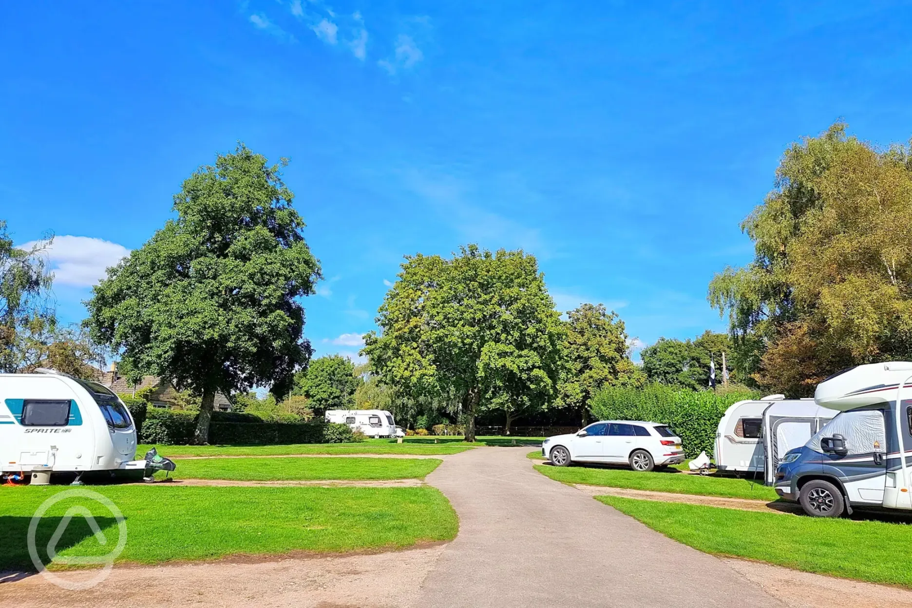 Electric hardstanding pitches with 16 amp hook ups and grass between pitches