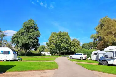 Electric hardstanding pitches with 16 amp hook ups and grass between pitches