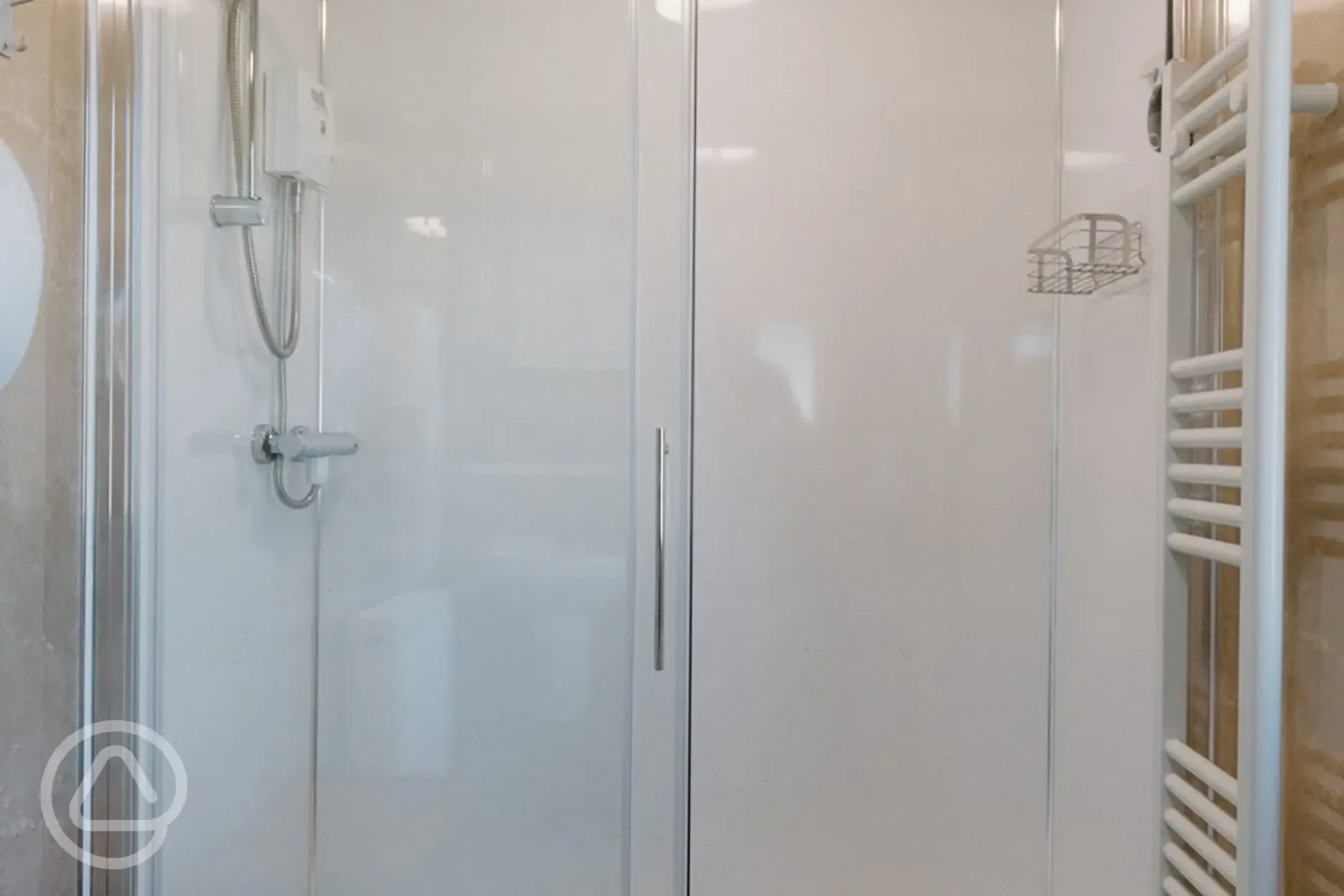 Shared shower with towel rails and a bench Shared shower with towel rails and a bench