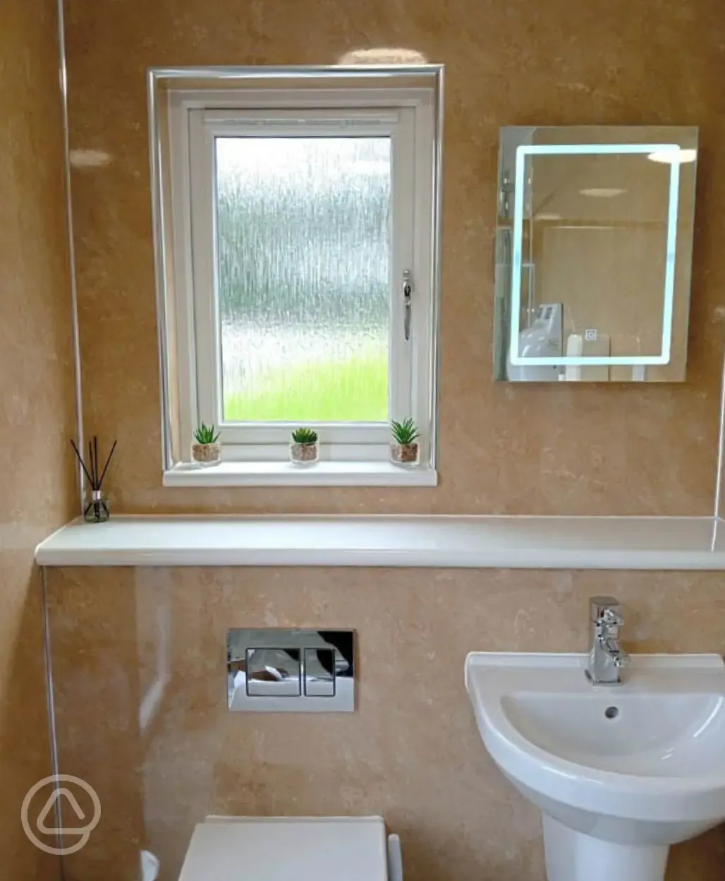 Shared bathroom with a light up mirror Shared bathroom with a light up mirror