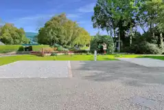 Fully serviced hardstanding pitches surrounded by trees Fully serviced hardstanding pitches surrounded by trees