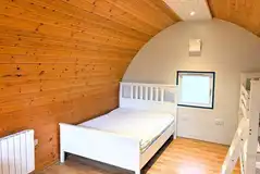 Six person camping pod interior with double bed