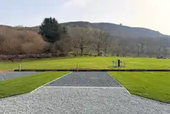 Electric hardstanding and grass pitches with views over the Cambrian mountains