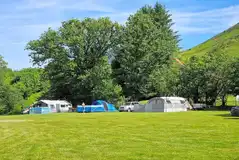 Electric grass pitches with space for an awning and parked car Electric grass pitches with space for an awning and parked car