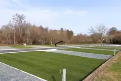 Electric hardstanding and grass pitches with a 4m x 9m grass area