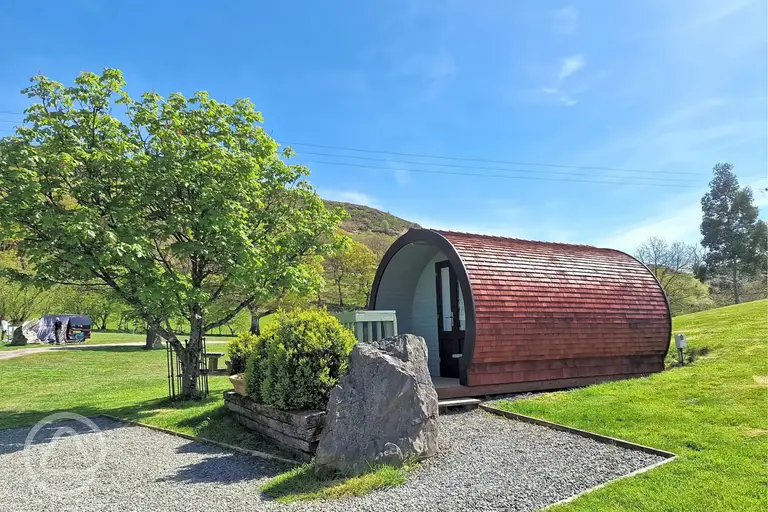 Gypsy pod at Woodlands Caravan Park with a small outdoor deck
