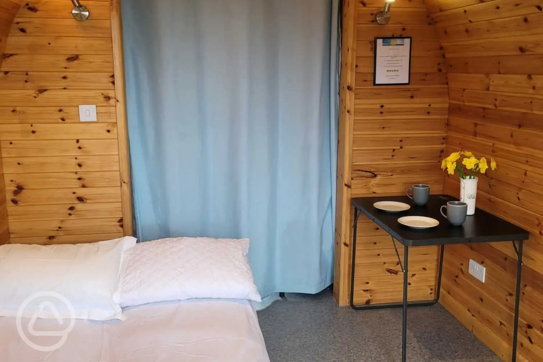 Camping pod interior with dividing curtain