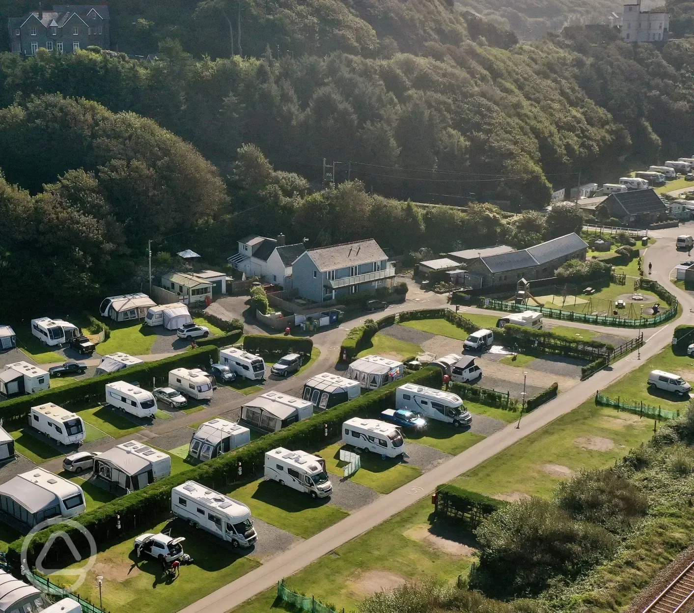 Aerial of Hendre Mynach backed by a forest covered hill