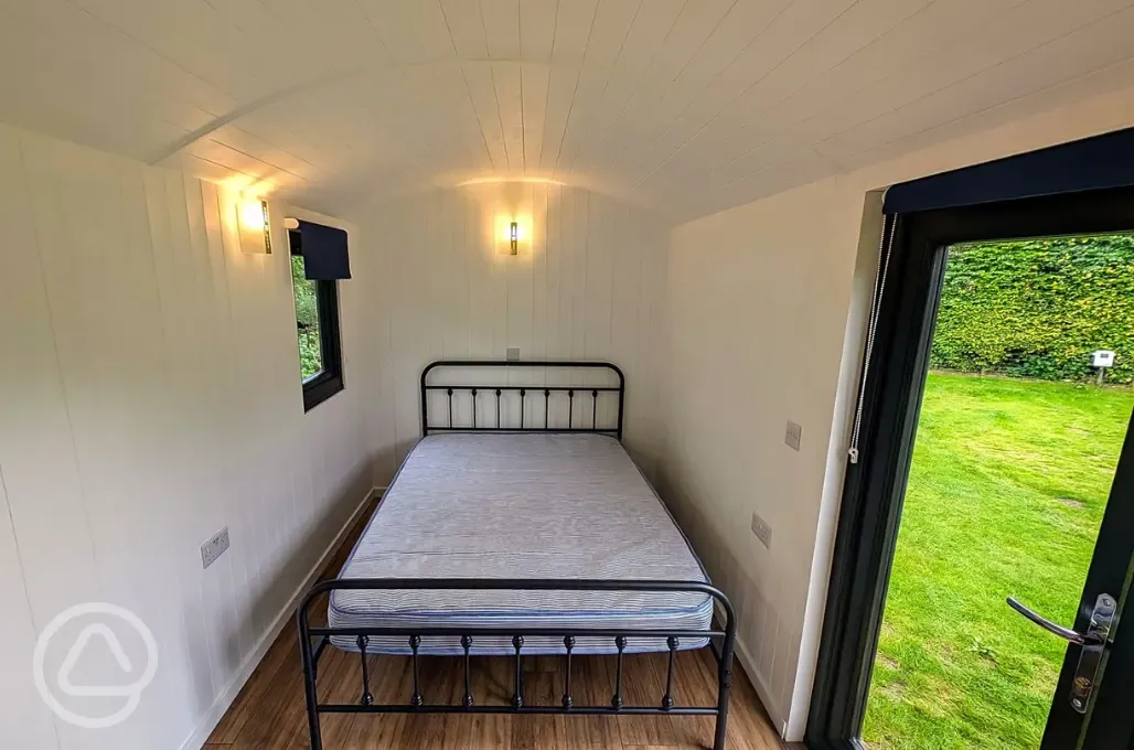 Shepherd's hut interior with a double bed