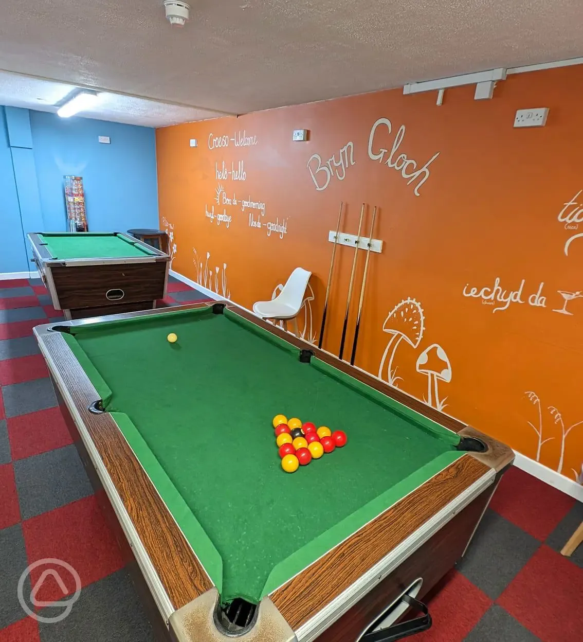 Indoor games room featuring two pool tables