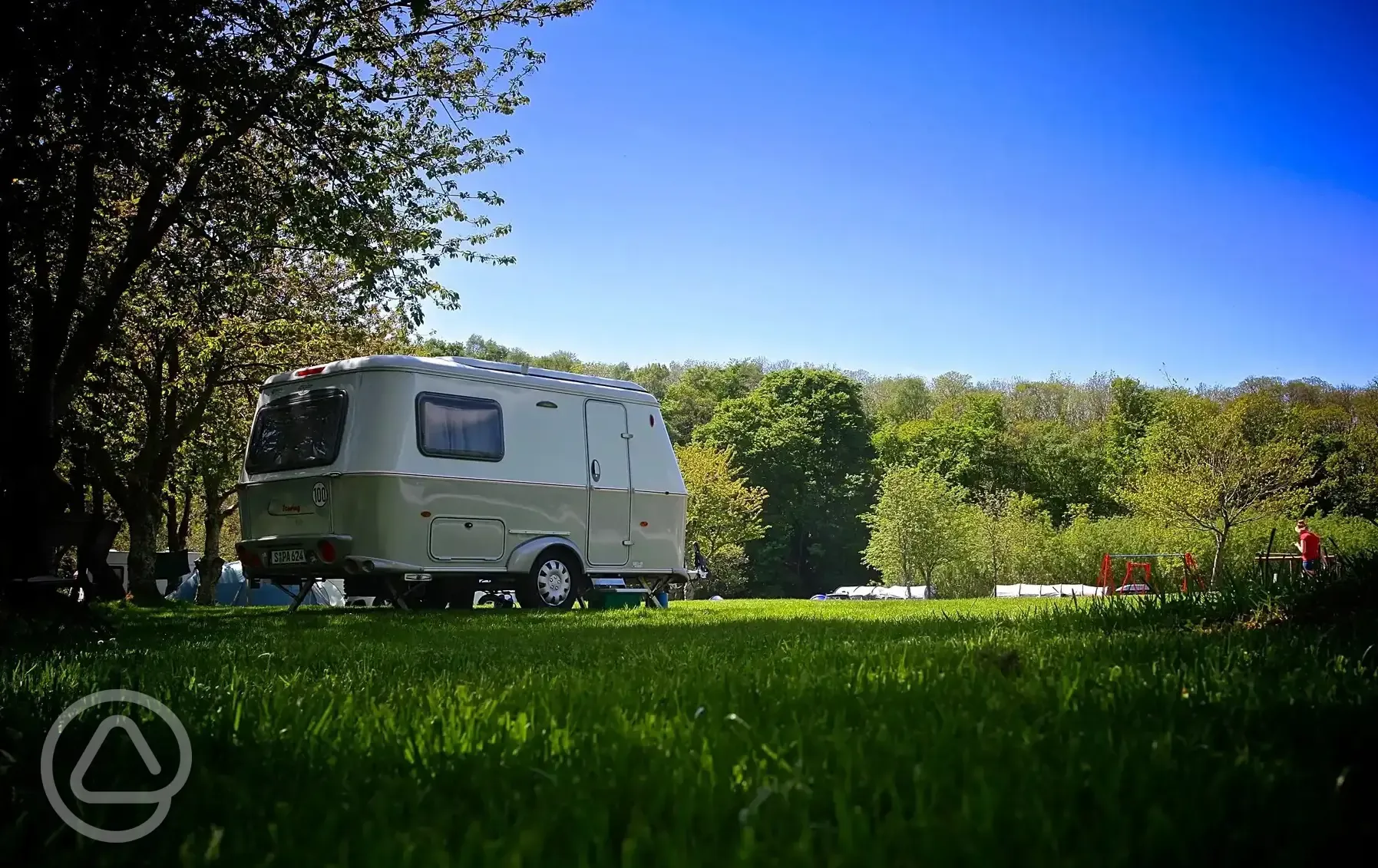 Grass caravan &amp; tent pitches with electric at Riverside Camping