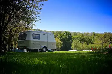 Grass caravan &amp; tent pitches with electric at Riverside Camping