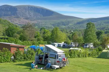 Small campervan on a grass pitch at Tyn-yr-Onnen Farm and Campsite