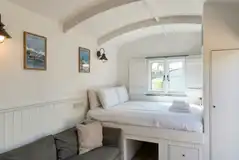 Shepherd's hut with a double bed and bedding