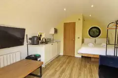 Glamping pod with a double bed, double sofa bed and kitchen