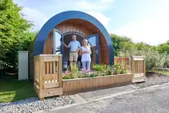 Glamping pod with a raised deck area and hot tub