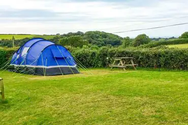 Grass and hardstanding pitches (optional electric) with countryside views