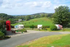 Grass and hardstanding pitches (optional electric) with countryside views