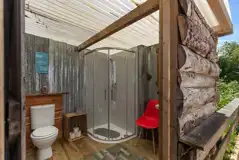 Geodome private adjacent bathroom with a toilet, shower and hand basin