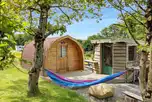 Y Cwtch glamping pod with a hammock and equipped kitchen cabin