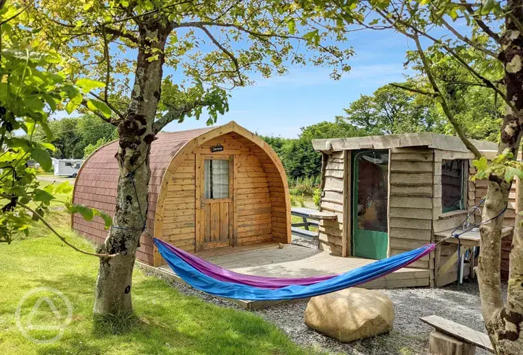 Y Cwtch glamping pod with a hammock and equipped kitchen cabin