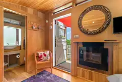 Y Caban electric fireplace, seating and ensuite bathroom