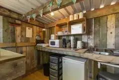 Pod private, sheltered outdoor kitchen with a fridge/freezer, hob and microwave