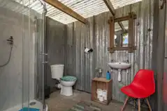 Geodome private adjacent bathroom with a toilet, shower and hand basin